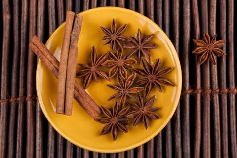 Cinnamon on yellow Stock Photos