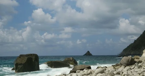 Cinque Terre timelapse with clouds in the sky, sea, rocks and pebble beach. Stock Footage 116953760