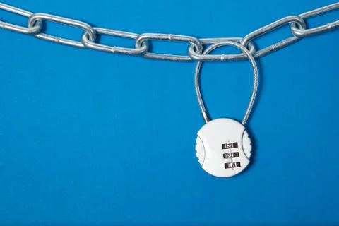 Cipher padlock on chain on blue background. Security concept. Stock Photos