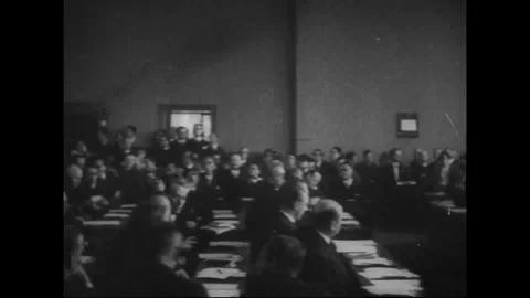 CIRCA 1933: Delegates seated in a hall during the League of Nations era Stock Footage 339065412