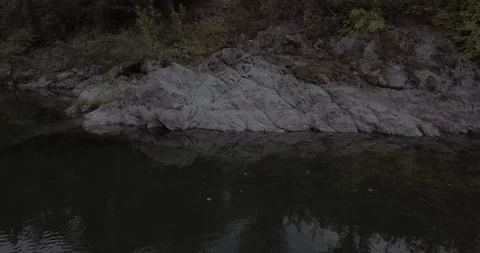 Circle around a rock by the river | Tracking shot | Drone Footage Stock Footage 137612936