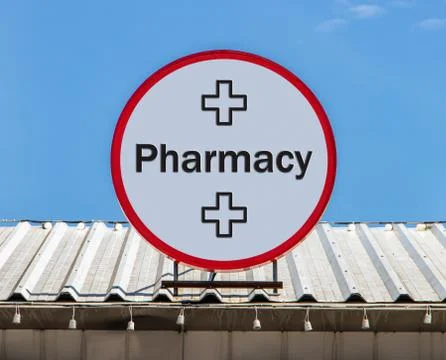 A Circle billboard with text Pharmacy, is installed on a roof. Foto stock