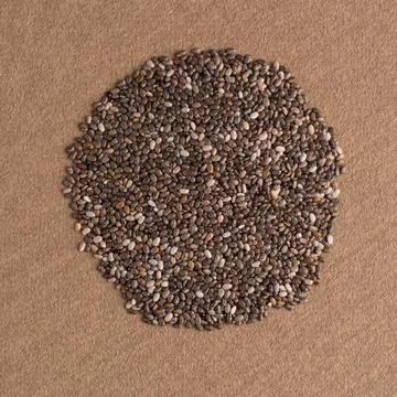 Circle of chia seeds Top view of chia seeds against brown vinyl background... 写真素材