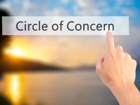 Circle of Concern - Hand pressing a button on blurred background concept on v Stock Photos