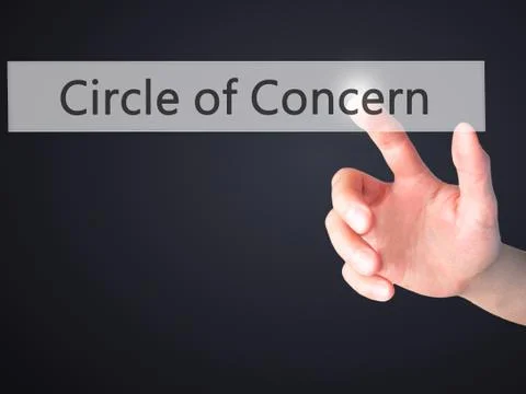 Circle of Concern - Hand pressing a button on blurred background concept on v Stock Photos