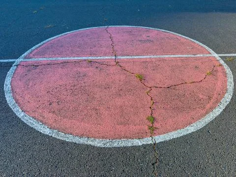 Circle with cracks on road surface in urban area during daylight Stock Photos
