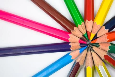 Circle design made with some different colored wood pencil crayons on white b Stock Photos