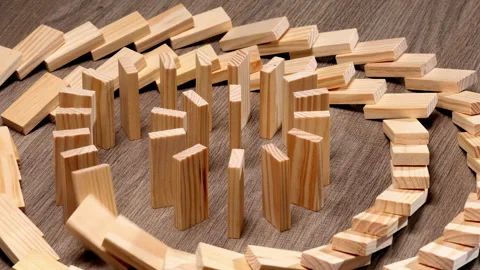 Circle domino effect concept, wooden dominoes falling in circular chain Stock Footage 331444982