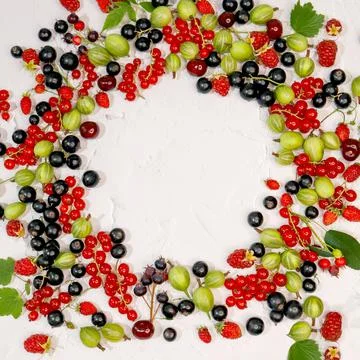 Circle frame of assorted wild fresh berries isolated on background. Stock Photos