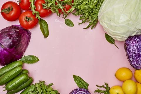 A circle of fresh vegetables on a pink background Stock Photos