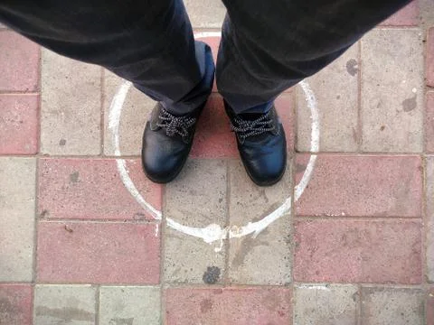 Circle on ground for standing in queue , Man feet top view in circle Stock Photos