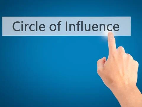 Circle of Influence - Hand pressing a button on blurred background concept on Stock Photos