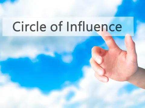 Circle of Influence - Hand pressing a button on blurred background concept on Stock Photos