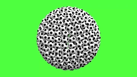 A circle made of many soccer balls is shown on a bright green background Stock Footage 335267706