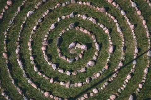 Circle made out of the bight rocks on the grass from the top 스톡 사진