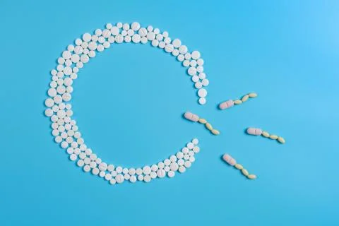 The circle is made up of white tablets on a blue background Stock Photos