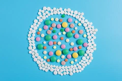 The circle is made up of white tablets on a blue background Stock Photos
