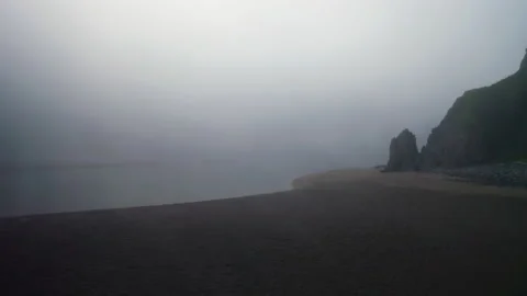 Circle panorama. Flight above deserted sand beach with rocky green hills in mist Stock Footage 169092485