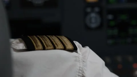 A circle on the pilot's shoulder straps with a view of the aircraft dashboard Stock Footage 224026058