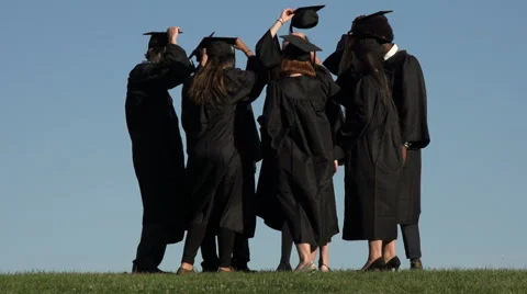 A circle of racially-diverse students throw mortarboards - slow motion Stock Footage 44112479