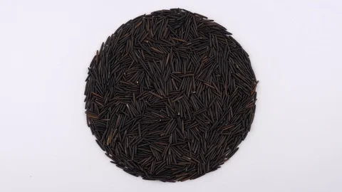 Circle shaped heap of raw wild / black rice rotating. Isolated on white. Stock Footage 88633139