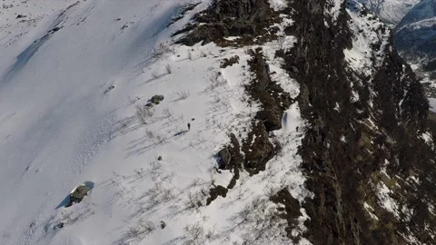 Circle shot of hiker walking on snow capped mountain Stock Footage 157883892