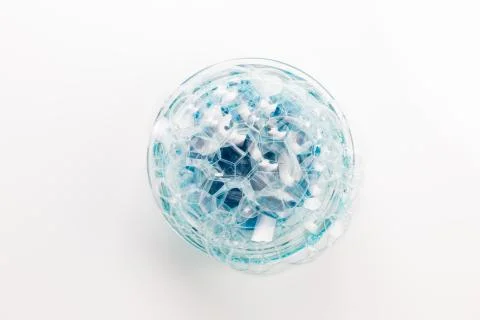 A circle of soap bubbles from blue shower gel on a white background. Stock Photos
