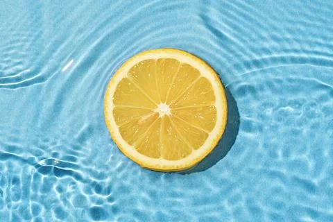 Circle texture fruit summer lemon in bright pool with wave movement fresh wat Stock Photos
