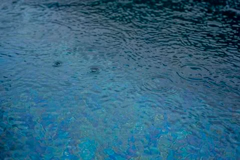 Circle water ripple wave surface background. Rain drop on swimming pool, blue Stock Photos