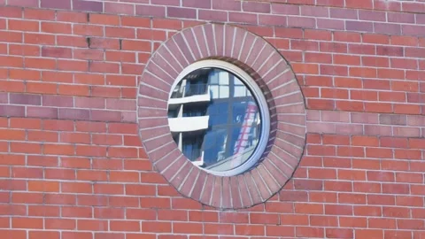 Circle window on a brick wall Stock Footage 339025578