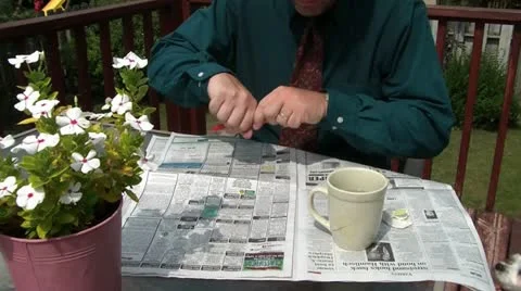 Circling Ads in Newspaper Stock Footage 12576265