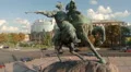 Circling around statue of man on horse, city architecture aerial HD Footage