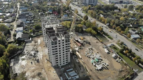 Circling the building under construction overlooking the road and the city. Stock Footage 96352896