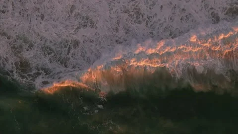 Circling cresting sunset lit Waves Video stock 237129088