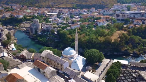 Circling drone shot of a mosque in Mostar with famous bridge in the backgroun Stock Footage 166251098