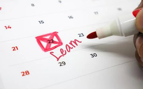 Circling an important Learn event on a calendar with a red marker, signifyi.. Stock Photos