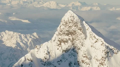 Circling a Mountain peak with clouds in the background Stock Footage 101909924