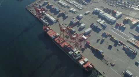 Circling Over Freight Ship and Loading Dock Stock Footage 11633554