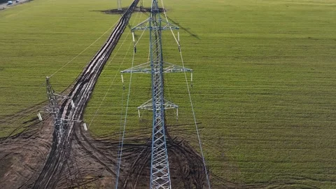 Circling view of steel erector workers strengthen a newly installed power line Stock Footage 209140840