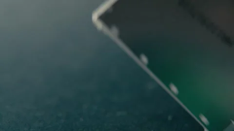 Circuit Board Being Held by Fingers for Inspection in a Dark Environment Stock Footage 331164573