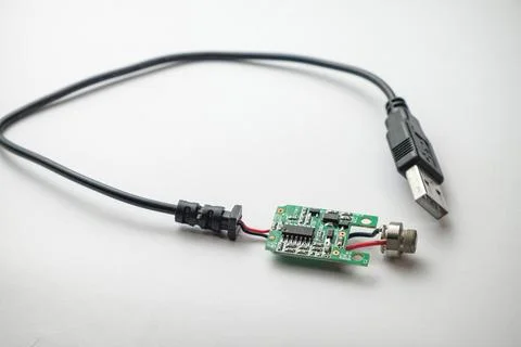 Circuit board connected to USB cable displays intricate technology detail Stock Photos