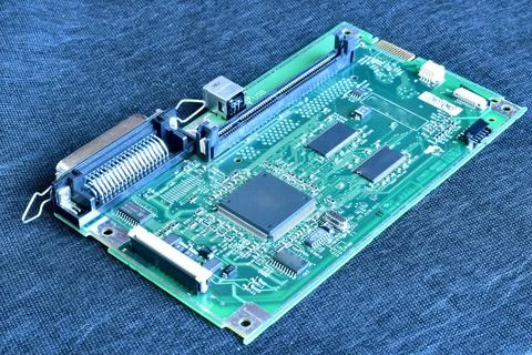 Circuit board lying on a dark table. Stock Photos