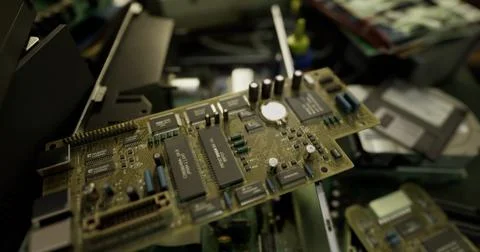 Circuit board placed among various electronic components and devices Stock Illustration