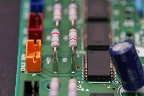 Circuit board's electronic components displaying resistors, chips, and a ca.. 스톡 사진