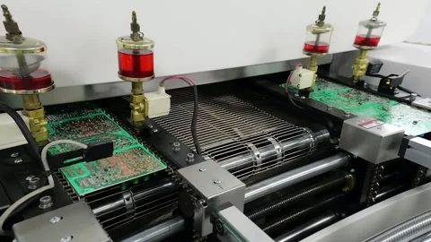 Circuit Boards Moving Through Reflow Soldering Oven on Mesh Conveyor Stock-Footage 348694226