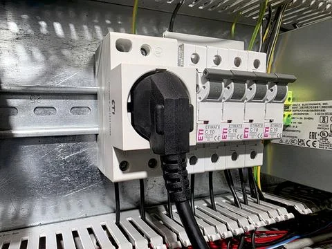 Circuit Breaker and Electrical Plug Assembled in a Modern Control Panel Stock-Fotos
