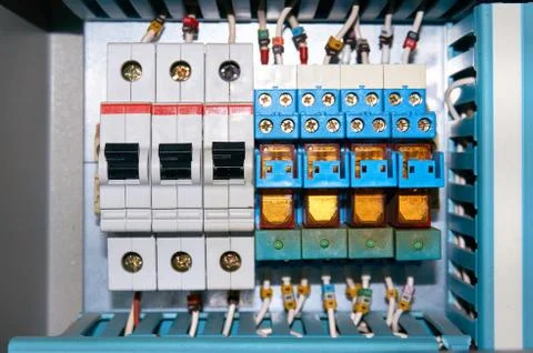 Circuit breakers and electrical relays with connected wires. Stock Photos