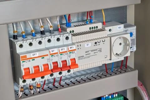 Circuit breakers, control relay, socket and thermostat in electrical Cabinet. Stock Photos