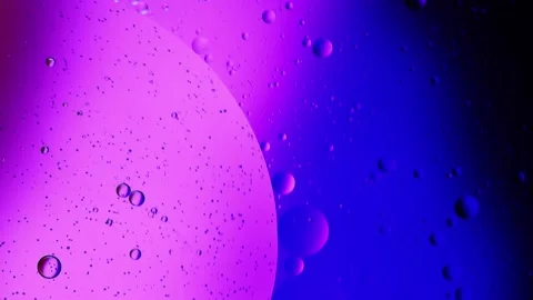 Circuit movements of oil elements into multicolored water with neon lights Stock Footage 235218094