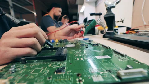 Circuits of a laptop are getting soldered by a repairman Stock Footage 149676434